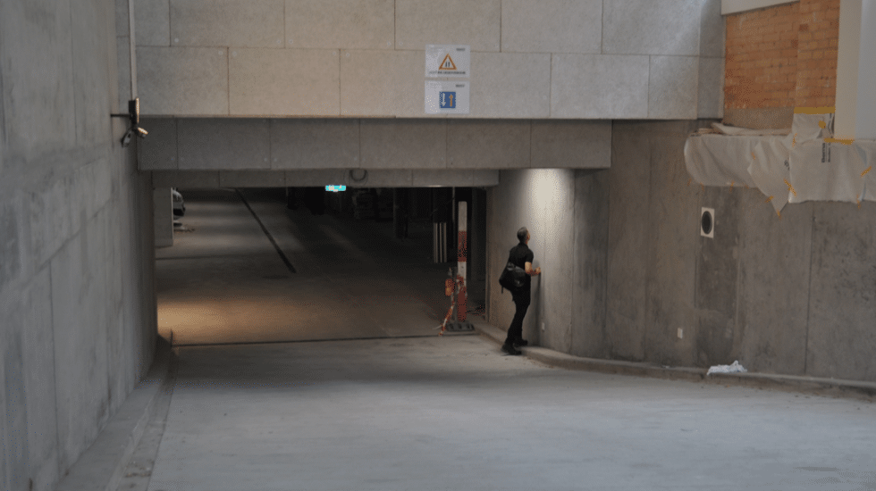 Parkhauseinfahrt aus Beton mit Anzeichen von einem Umbau inklsuive einem Inspektor